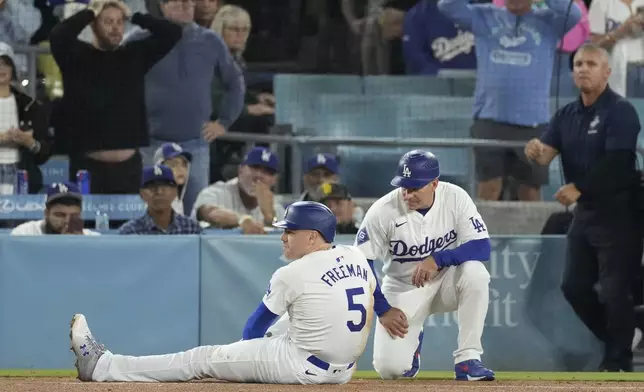 Los Angeles Dodgers' Freddie Freeman (5) suffers an injury after grounding out during the seventh inning of a baseball game against the San Diego Padres, Thursday, Sept. 26, 2024, in Los Angeles. (AP Photo/Mark J. Terrill)