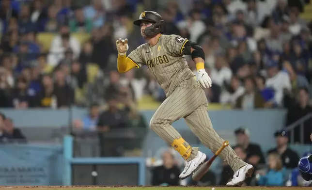 San Diego Padres' Kyle Higashioka watches his ground rule double during the fifth inning of a baseball game against the Los Angeles Dodgers Thursday, Sept. 26, 2024, in Los Angeles. (AP Photo/Ashley Landis)