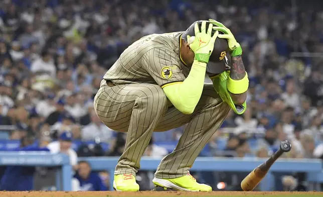 San Diego Padres' Manny Machado reacts after striking out during the fourth inning of a baseball game against the Los Angeles Dodgers, Tuesday, Sept. 24, 2024, in Los Angeles. (AP Photo/Mark J. Terrill)