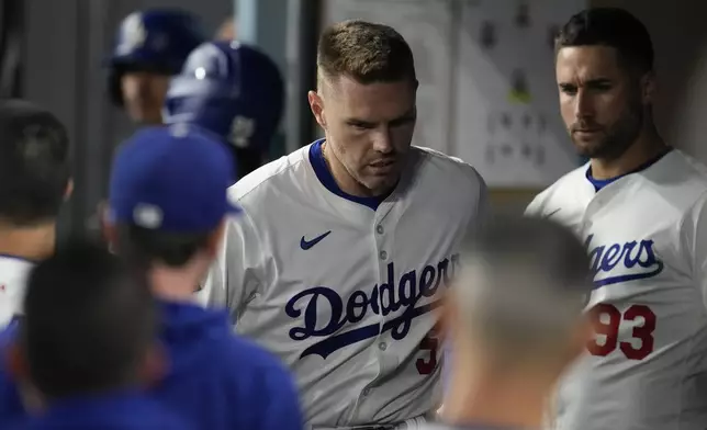 Los Angeles Dodgers' Freddie Freeman reacts in the dugout after an injury during the seventh inning of a baseball game against the San Diego Padres Thursday, Sept. 26, 2024, in Los Angeles. (AP Photo/Ashley Landis)