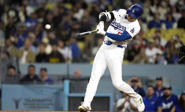 Los Angeles Dodgers designated hitter Shohei Ohtani hits a double during the first inning of a baseball game against the San Diego Padres, Tuesday, Sept. 24, 2024, in Los Angeles. (AP Photo/Mark J. Terrill)