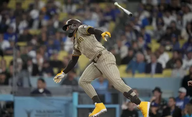 San Diego Padres' Fernando Tatis Jr. watches his single during the first inning of a baseball game against the Los Angeles Dodgers, Thursday, Sept. 26, 2024, in Los Angeles. (AP Photo/Ashley Landis)