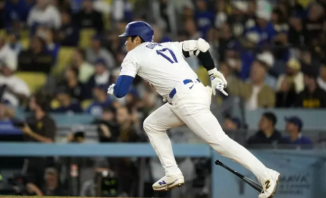 Los Angeles Dodgers' Shohei Ohtani heads to first for a double during the first inning of a baseball game against the San Diego Padres, Tuesday, Sept. 24, 2024, in Los Angeles. (AP Photo/Mark J. Terrill)