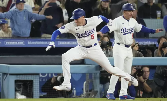 Los Angeles Dodgers' Freddie Freeman (5) suffers an injury after grounding out during the seventh inning of a baseball game against the San Diego Padres, Thursday, Sept. 26, 2024, in Los Angeles. (AP Photo/Mark J. Terrill)