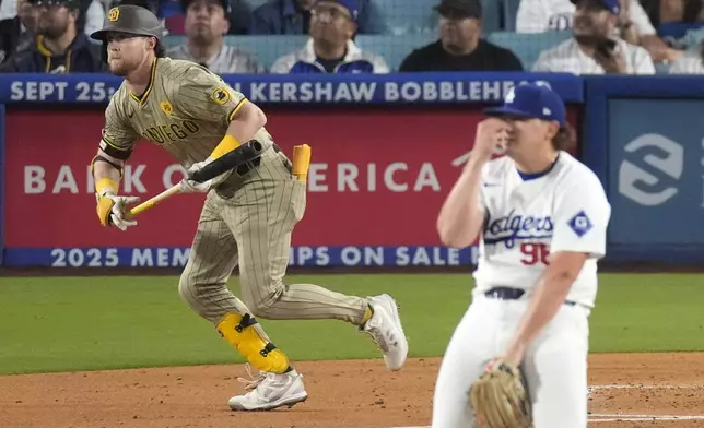 San Diego Padres' Jake Cronenworth, left, heads to first for a two-run home run as Los Angeles Dodgers starting pitcher Landon Knack watches during the second inning of a baseball game, Tuesday, Sept. 24, 2024, in Los Angeles. (AP Photo/Mark J. Terrill)