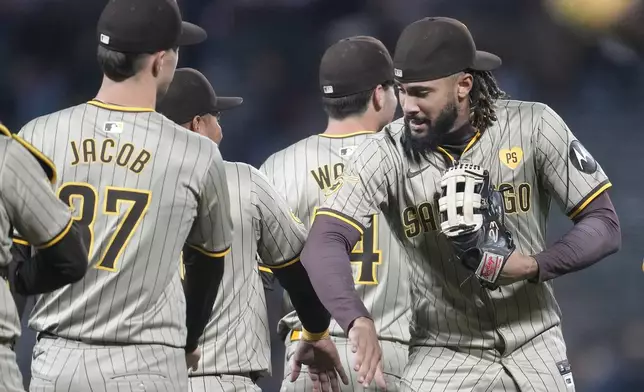 San Diego Padres pitcher Alek Jacob, left, celebrates with right fielder Fernando Tatis Jr. after the Padres defeated the San Francisco Giants in a baseball game in San Francisco, Saturday, Sept. 14, 2024. (AP Photo/Jeff Chiu)