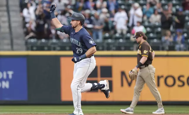 Seattle Mariners' Cal Raleigh, left, runs the bases after hitting a home run off San Diego Padres starting pitcher Yu Darvish as second baseman Jake Cronenworth, right, looks on during the first inning of a baseball game, Tuesday, Sept. 10, 2024, in Seattle. (AP Photo/Jason Redmond)