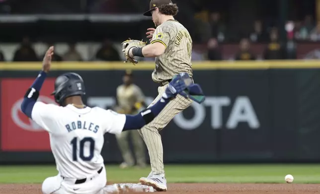 Seattle Mariners' Victor Robles slides into second as San Diego Padres second baseman Jake Cronenworth loses the ball on a missed-catch error during the third inning of a baseball game, Wednesday, Sept. 11, 2024, in Seattle. (AP Photo/Jason Redmond)