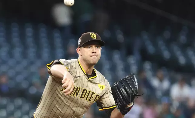 San Diego Padres starting pitcher Michael King throws to first base in an attempt to get Seattle Mariners' Josh Rojas out during the third inning of a baseball game, Wednesday, Sept. 11, 2024, in Seattle. (AP Photo/Jason Redmond)