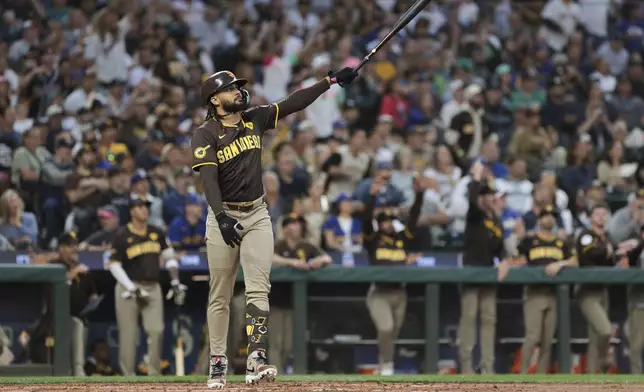 San Diego Padres' Fernando Tatis Jr. follows through after hitting a three-run home run off Seattle Mariners starting pitcher George Kirby to score Donovan Solano and Luis Arraez during the third inning of a baseball game, Tuesday, Sept. 10, 2024, in Seattle. (AP Photo/Jason Redmond)