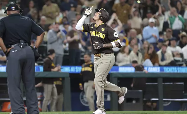 San Diego Padres' Manny Machado celebrates at home after hitting a two-run home run off Seattle Mariners starting pitcher George Kirby during the sixth inning of a baseball game, Tuesday, Sept. 10, 2024, in Seattle. (AP Photo/Jason Redmond)