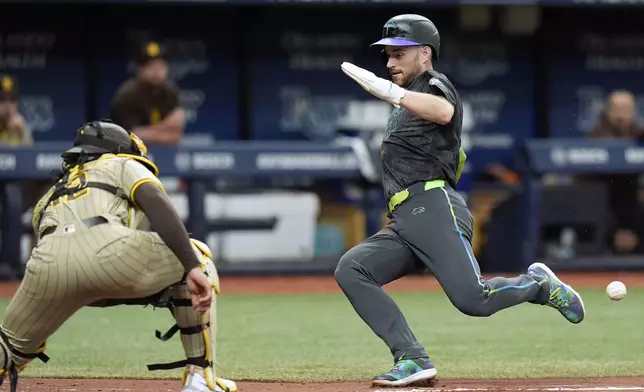 Tampa Bay Rays' Brandon Lowe, right, prepares to score ahead of the throw to San Diego Padres catcher Luis Campusano on a two-run single by Jose Caballero during the fourth inning of a baseball game Saturday, Aug. 31, 2024, in St. Petersburg, Fla. (AP Photo/Chris O'Meara)