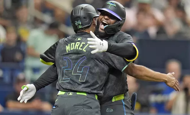 Tampa Bay Rays' Junior Caminero celebrates his three-run home run off San Diego Padres starting pitcher Randy Vasquez with Christopher Morel (24) during the second inning of a baseball game Saturday, Aug. 31, 2024, in St. Petersburg, Fla. (AP Photo/Chris O'Meara)