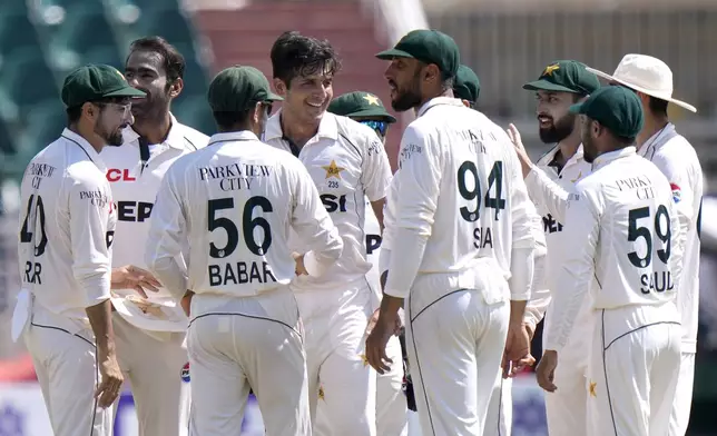 Pakistan's Mir Hamza, center, celebrates with teammates after taking wicket of Bangladesh's Mominul Haque during the third day of second test cricket match between Pakistan and Bangladesh, in Rawalpindi, Pakistan, Sunday, Sept. 1, 2024. (AP Photo/Anjum Naveed)