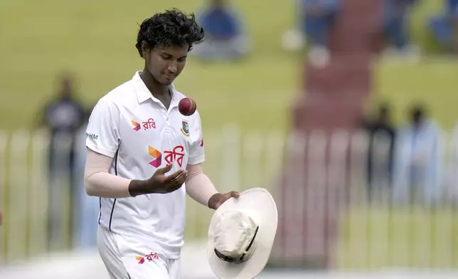 Bangladesh's Hasan Mahmud tosses the ball after taking his fifth wicket as he walks off the field on the end of Pakistan second innings during the fourth day of second test cricket match between Pakistan and Bangladesh, in Rawalpindi, Pakistan, Monday, Sept. 2, 2024. (AP Photo/Anjum Naveed)