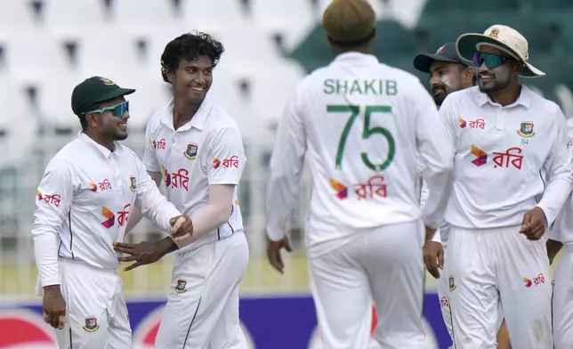 Bangladesh's Hasan Mahmud, second left, celebrates with teammates after taking the wicket of Pakistan's Mohammad Ali during the fourth day of second test cricket match between Pakistan and Bangladesh, in Rawalpindi, Pakistan, Monday, Sept. 2, 2024. (AP Photo/Anjum Naveed)