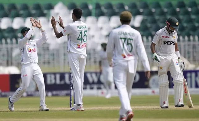 Bangladesh's Nahid Rana, second left, celebrates with teammate after taking the wicket of Pakistan's Babar Azam, right, during the fourth day of second test cricket match between Pakistan and Bangladesh, in Rawalpindi, Pakistan, Monday, Sept. 2, 2024. (AP Photo/Anjum Naveed)