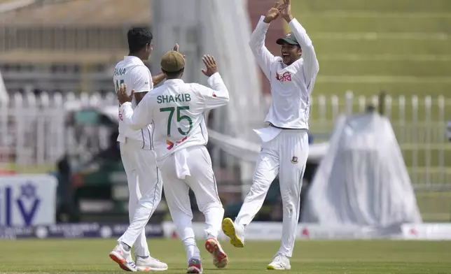 Bangladesh's Nahid Rana, left, celebrates with teammates after taking the wicket of Pakistan's Saud Shakeel during the fourth day of second test cricket match between Pakistan and Bangladesh, in Rawalpindi, Pakistan, Monday, Sept. 2, 2024. (AP Photo/Anjum Naveed)