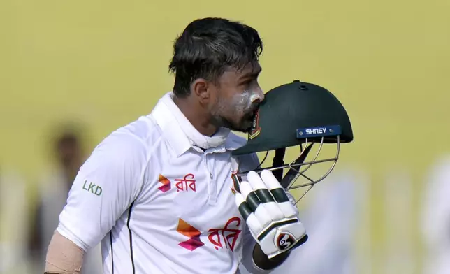 Bangladesh's Litton Das kisses his helmet after scoring century during the third day of second test cricket match between Pakistan and Bangladesh, in Rawalpindi, Pakistan, Sunday, Sept. 1, 2024. (AP Photo/Anjum Naveed)