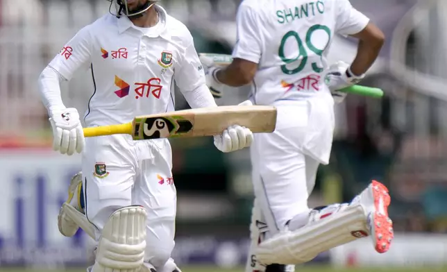 Bangladesh's Mominul Haque, left, and Najmul Hossain Shanto run between the wickets during the fifth day of second test cricket match between Pakistan and Bangladesh, in Rawalpindi, Pakistan, Tuesday, Sept. 3, 2024. (AP Photo/Anjum Naveed)