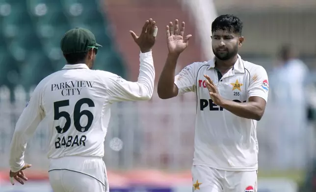 Pakistan's Khurram Shahzad, right, celebrates with teammate after taking the wicket of Bangladesh's Shadman Islam during the fifth day of second test cricket match between Pakistan and Bangladesh, in Rawalpindi, Pakistan, Tuesday, Sept. 3, 2024. (AP Photo/Anjum Naveed)