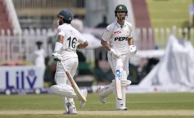 Pakistan's Salman Ali Agha, right, Pakistan's Mohammad Rizwan run between the wickets during the fourth day of second test cricket match between Pakistan and Bangladesh, in Rawalpindi, Pakistan, Monday, Sept. 2, 2024. (AP Photo/Anjum Naveed)