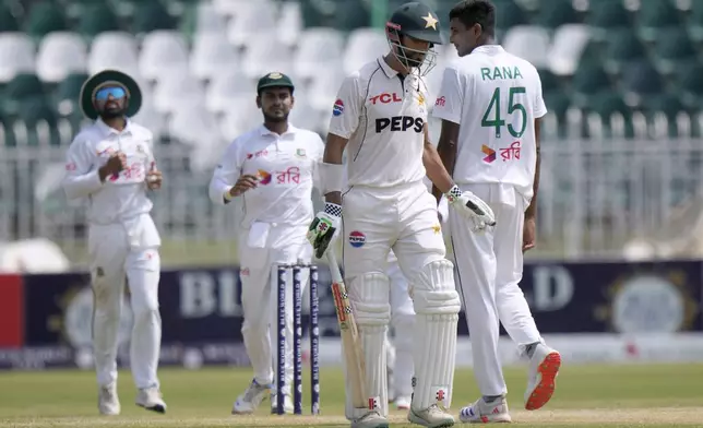 Pakistan's Shan Masood, second right, reacts as Bangladesh's Nahid Rana, right, celebrates after his dismissal during the fourth day of second test cricket match between Pakistan and Bangladesh, in Rawalpindi, Pakistan, Monday, Sept. 2, 2024. (AP Photo/Anjum Naveed)