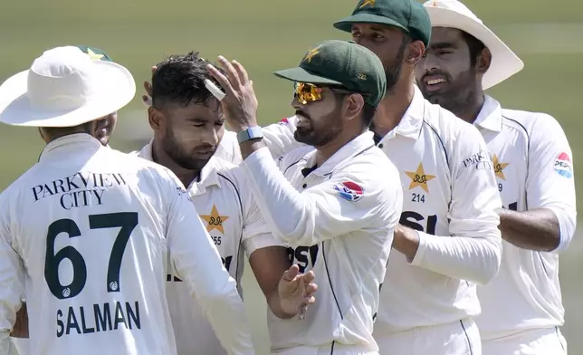 Pakistan's Khurram Shahzad, center, celebrates with teammates after taking wickets of Bangladesh's Najmul Hossain Shanto during the third day of second test cricket match between Pakistan and Bangladesh, in Rawalpindi, Pakistan, Sunday, Sept. 1, 2024. (AP Photo/Anjum Naveed)