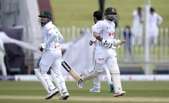 Bangladesh's Litton Das, right, and Mehidy Hasan Mirza run between the wickets during the third day of second test cricket match between Pakistan and Bangladesh, in Rawalpindi, Pakistan, Sunday, Sept. 1, 2024. (AP Photo/Anjum Naveed)