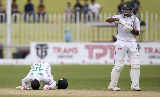 Bangladesh's Mushfiqur Rahim, left, and Shakib Al Hasan celebrates after winning the second test cricket match against Pakistan, in Rawalpindi, Pakistan, Tuesday, Sept. 3, 2024. (AP Photo/Anjum Naveed)