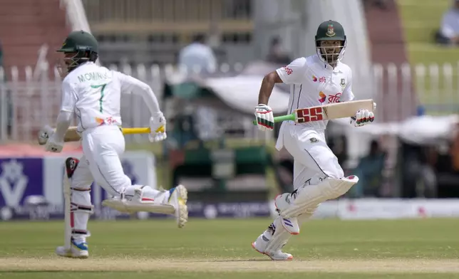 Bangladesh's Najmul Hossain Shanto, right, and Mominul Haque run between the wickets during the fifth day of second test cricket match between Pakistan and Bangladesh, in Rawalpindi, Pakistan, Tuesday, Sept. 3, 2024. (AP Photo/Anjum Naveed)