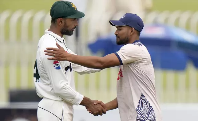 Bangladesh's Najmul Hossain Shanto, right, shakes hand with Pakistan's Shan Masood after winning the second test cricket match against Pakistan, in Rawalpindi, Pakistan, Tuesday, Sept. 3, 2024. (AP Photo/Anjum Naveed)