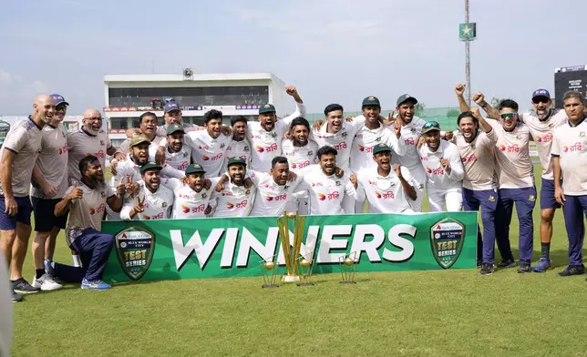 Bangladesh's officials and players pose for photograph after winning test cricket series against Pakistan, in Rawalpindi, Pakistan, Tuesday, Sept. 3, 2024. (AP Photo/Anjum Naveed)