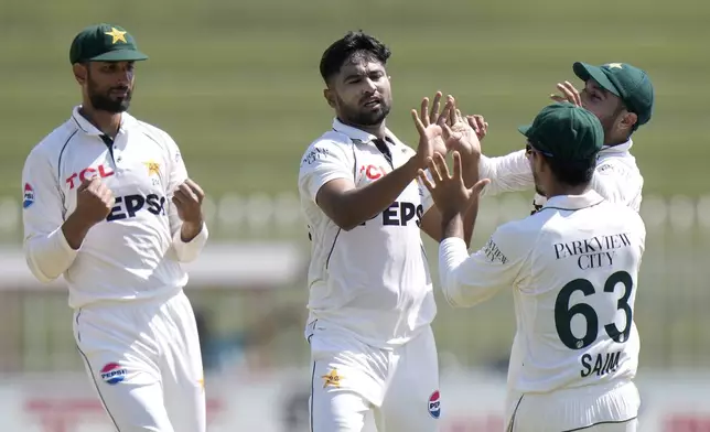 Pakistan's Khurram Shahzad, center, celebrates with teammates after taking wickets of Bangladesh's Najmul Hossain Shanto during the third day of second test cricket match between Pakistan and Bangladesh, in Rawalpindi, Pakistan, Sunday, Sept. 1, 2024. (AP Photo/Anjum Naveed)