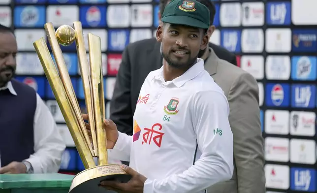 Bangladesh's Najmul Hossain Shanto holds trophy after winning the test cricket series against Pakistan at a ceremony, in Rawalpindi, Pakistan, Tuesday, Sept. 3, 2024. (AP Photo/Anjum Naveed)