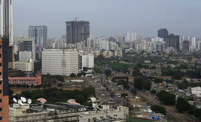 A view of a residential area is seen with skyscrapers in the background in Karachi, Pakistan, Thursday, Aug. 29, 2024. (AP Photo/Fareed Khan)