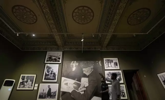 Visitors look at pictures of Pakistan's independence movement which was started by Muhammad Ali Jinnah, later known to be the founder of Pakistan, at the museum set up in historical building "Mohatta Palace" in Karachi, Pakistan, Friday, May 24, 2024. (AP Photo/Fareed Khan)