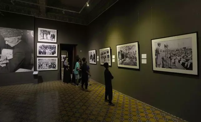 Visitors look at pictures of Pakistan's independence movement which was started by Muhammad Ali Jinnah, later known to be the founder of Pakistan, in the museum set up in the historical building "Mohatta Palace" in Karachi, Pakistan, Friday, May 24, 2024. (AP Photo/Fareed Khan)