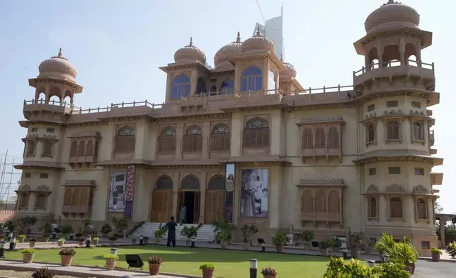 A visitor takes a picture with his mobile phone of historical building "Mohatta Palace," which was built in 1920s and has since been turned into a museum, in Karachi, Pakistan, Friday, May 24, 2024. (AP Photo/Fareed Khan)