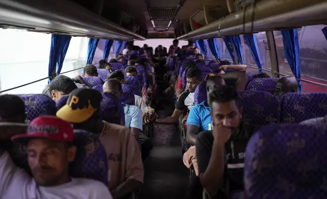 Migrants sit on a northbound bus heading to Costa Rica as they wait to leave Lajas Blancas, Panama, Thursday, Sept. 26, 2024, after walking across the Darien Gap from Colombia in hopes of reaching the U.S. (AP Photo/Matias Delacroix)