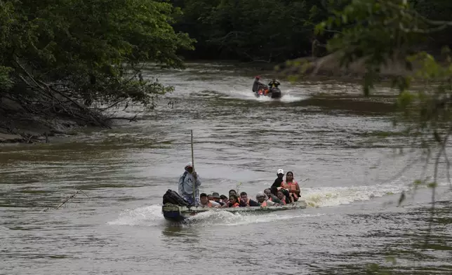 A boat takes migrants to Lajas Blanca, Panama, Thursday, Sept. 26, 2024, after their trek across the Darien Gap from Colombia in hopes of reaching the U.S. (AP Photo/Matias Delacroix)