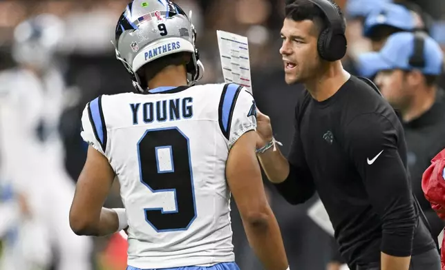 Carolina Panthers head coach Dave Canales right talks to quarterback Bryce Young (9) during the second half of an NFL football game against the New Orleans Saints, Sunday, Sept. 8, 2024, in New Orleans. (AP Photo/Matthew Hinton)