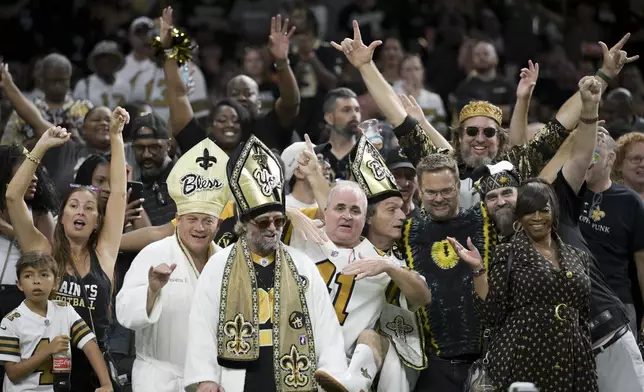 New Orleans Saints fans celebrate during the second half of an NFL football game against the Carolina Panthers, Sunday, Sept. 8, 2024, in New Orleans. (AP Photo/Matthew Hinton)