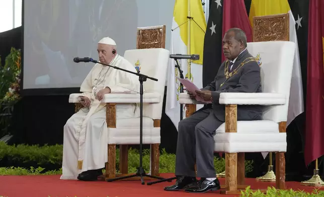 Pope Francis, left, listens to Papua New Guinea's Governor General Bob Dadae outside the APEC Haus in Port Moresby, Saturday, Sept. 7, 2024, before meeting with Papua New Guinea's political and religious authorities, the diplomatic corps, entrepreneurs, representatives of civil society and culture. As a second leg of his 11-day trip to Asia and Oceania Pope Francis's visit to Papua New Guinea will take him to a remote part of the South Pacific island nation where Christianity is a recent addition to traditional spiritual beliefs developed over millennia. (AP Photo/Gregorio Borgia)