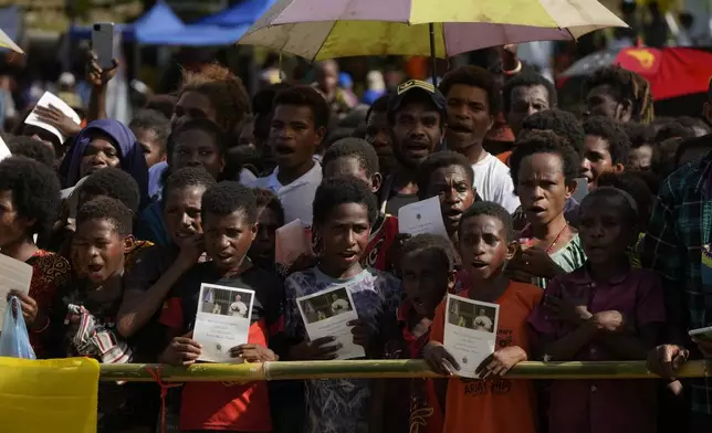 Pupils of the Holy Trinity Humanistic School and faithful wait for Pope Francis in Baro, near Vanimo, Papua New Guinea, Sunday, Sept. 8, 2024. the Holy Trinity Humanistic School in Baro, near Vanimo, Papua New Guinea, Sunday, Sept. 8, 2024. Pope Francis celebrated the Catholic Church of the peripheries on Sunday as he traveled to the remote jungles of Papua New Guinea, bringing with him a ton of medicine and toys and a message of love overcoming violence for the people who live there.(AP Photo/Gregorio Borgia)