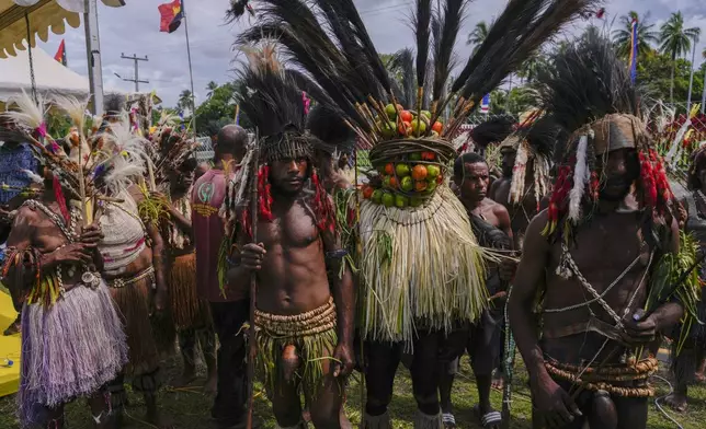 Papuan indigenous people wait for Pope Francis in Vanimo, Papua New Guinea, Sunday, Sept. 8, 2024. Pope Francis celebrated the Catholic Church of the peripheries on Sunday as he traveled to the remote jungles of Papua New Guinea, bringing with him a ton of medicine and toys and a message of love overcoming violence for the people who live there.(AP Photo/Gregorio Borgia)