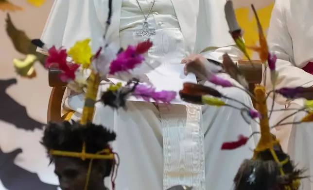 Pope Francis attends a traditional dance performed by the pupil of the Caritas Technical Secondary School in Port Moresby, Saturday, Sept. 7, 2024. As a second leg of his 11-day trip to Asia and Oceania Pope Francis's visit to Papua New Guinea will take him to a remote part of the South Pacific island nation where Christianity is a recent addition to traditional spiritual beliefs developed over millennia. (AP Photo/Gregorio Borgia)