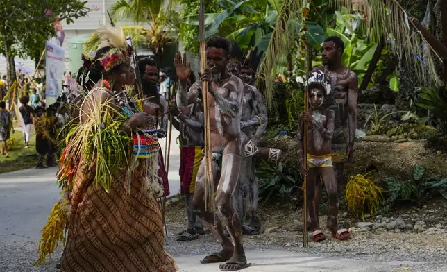 Papuan indigenous people wait for Pope Francis in Vanimo, Papua New Guinea, Sunday, Sept. 8, 2024. Pope Francis celebrated the Catholic Church of the peripheries on Sunday as he traveled to the remote jungles of Papua New Guinea, bringing with him a ton of medicine and toys and a message of love overcoming violence for the people who live there.(AP Photo/Gregorio Borgia)