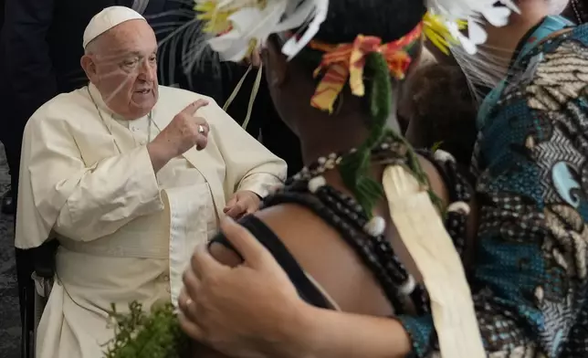 Pope Francis meets performers outside the APEC Haus in Port Moresby, Saturday, Sept. 7, 2024, where Pope Francis and Papua New Guinea's Governor General Bob Dadae attended a traditional dance performance. As a second leg of his 11-day trip to Asia and Oceania Pope Francis's visit to Papua New Guinea will take him to a remote part of the South Pacific island nation where Christianity is a recent addition to traditional spiritual beliefs developed over millennia. (AP Photo/Gregorio Borgia)