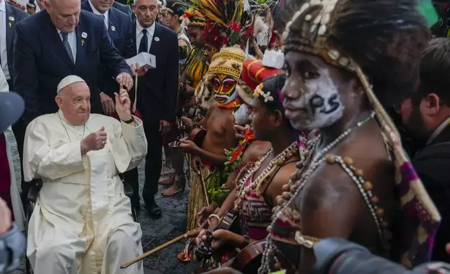 Pope Francis meets performers outside the APEC Haus in Port Moresby, Saturday, Sept. 7, 2024, where Pope Francis and Papua New Guinea's Governor General Bob Dadae attended a traditional dance performance. As a second leg of his 11-day trip to Asia and Oceania Pope Francis's visit to Papua New Guinea will take him to a remote part of the South Pacific island nation where Christianity is a recent addition to traditional spiritual beliefs developed over millennia. (AP Photo/Gregorio Borgia)